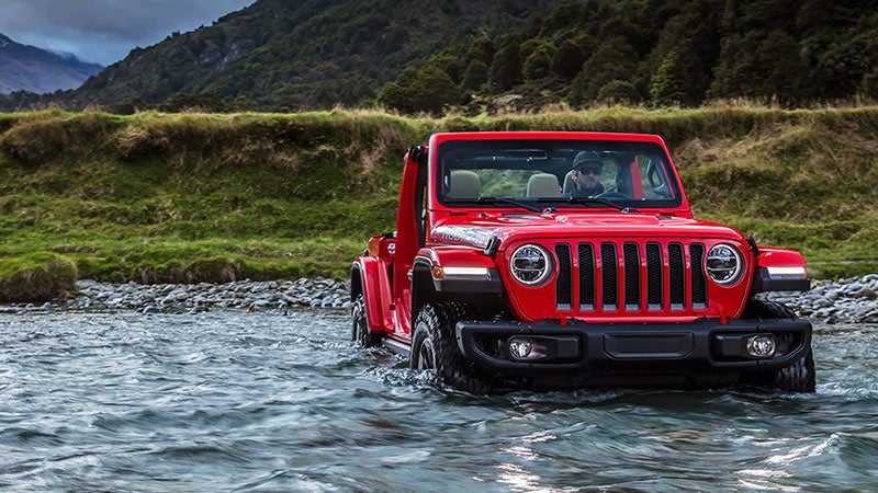 red jeep 2023 in water